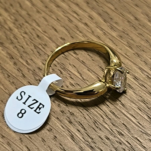 Gold ring with white crystal stone new, size 8