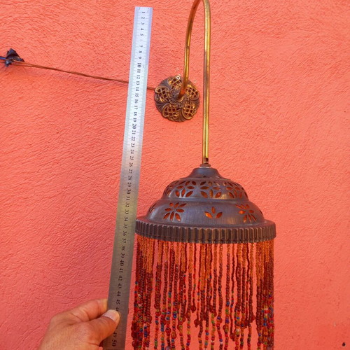 Wall light with beaded fringe