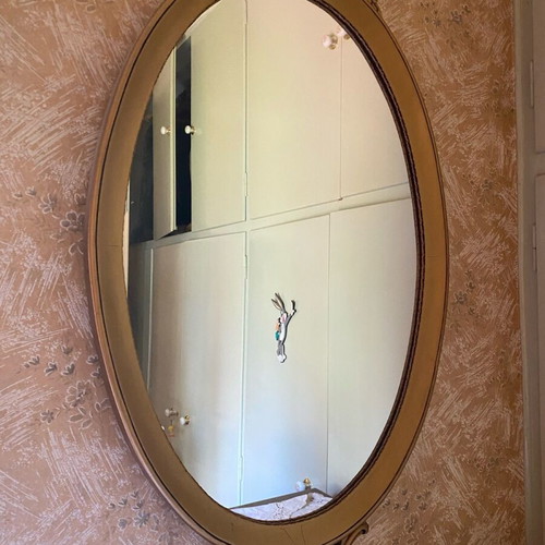 Oval carved wall mirror used, wood with gold leaf