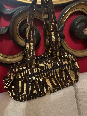 Shoulder bag used with gold all-over logo print on dark background