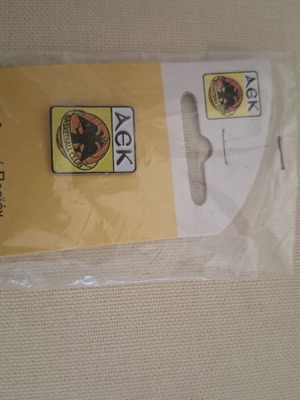 AEK pin and keychain new, authentic collectible