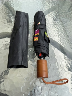 Folding umbrella new, black with colorful print and brown handle