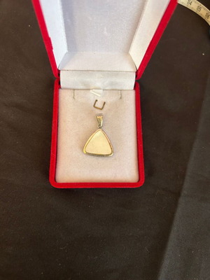 Silver pendant with white stone used