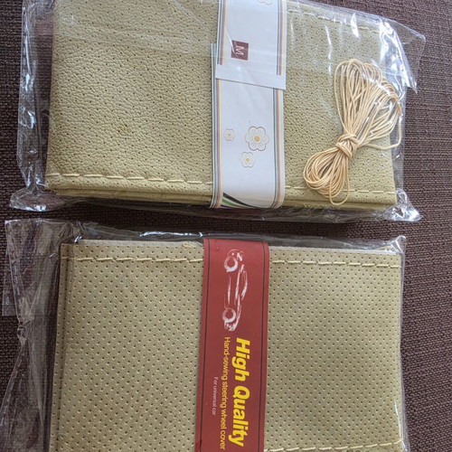 Steering wheel cover beige set of 2, new