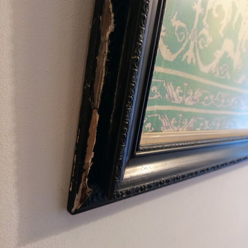Handmade embroidery in large black Corinthian-style frame, used