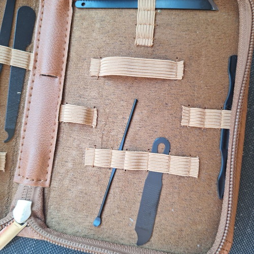 Skin and nail care tools set in small brown case