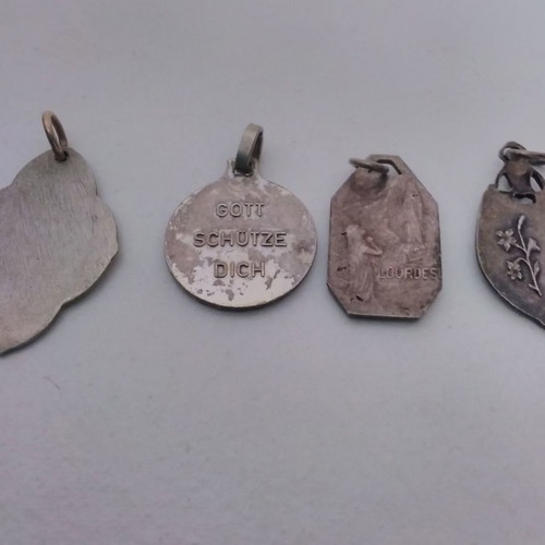 Silver pendant necklace used with zodiac and catholic figures