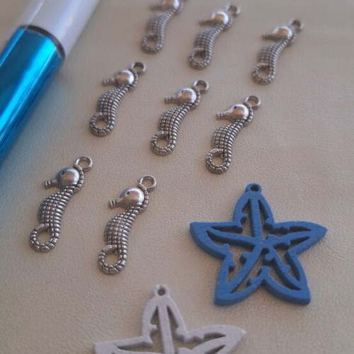 8 metal seahorse charms and 2 wooden starfish