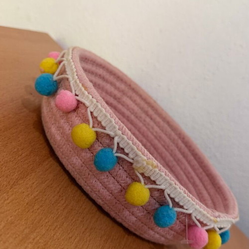 Handmade pink basket with colorful pom poms like new