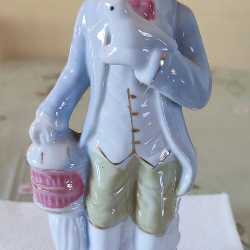Vintage porcelain figurine Victorian man with bird and cage