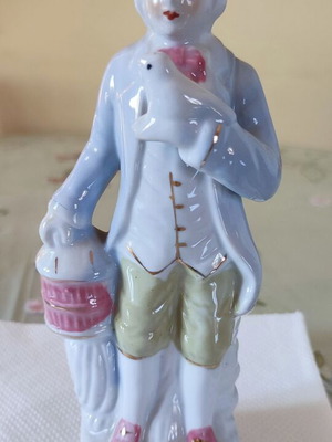 Vintage porcelain figurine Victorian man with bird and cage