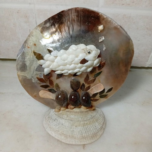 Handmade table decoration with fish made of natural shells like new