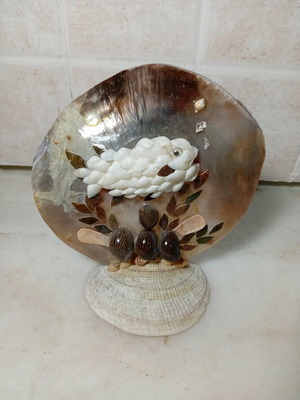 Handmade table decoration with fish made of natural shells like new