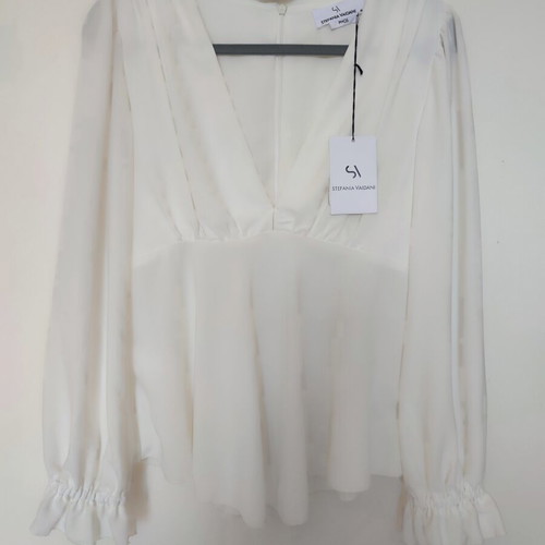 Stefania Vaidani white blouse with deep V neckline
