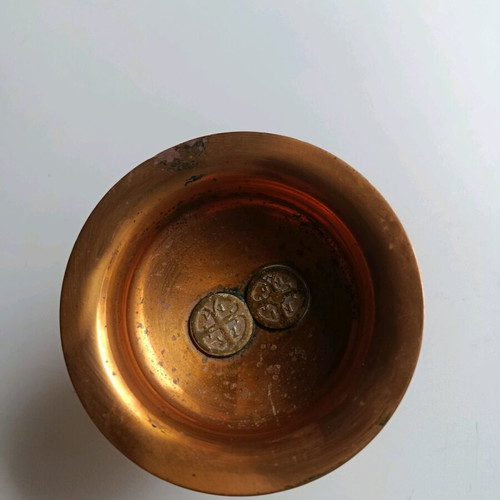 Copper decoration with two old coins used