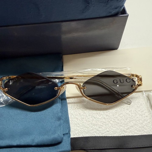 Gucci GG1604S 001 sunglasses, gold frame with black lenses