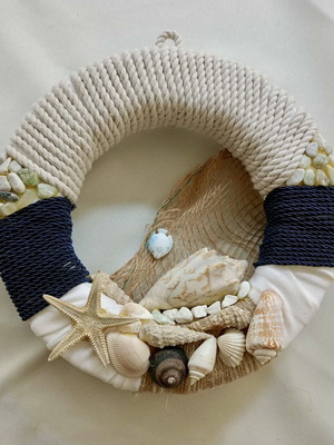 Handmade decorative wreath with thick rope, shells, and stones