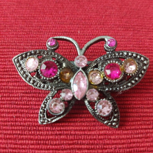 Metal butterfly brooch with pink and fuchsia crystals