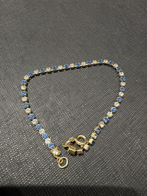 Yellow gold-coloured tennis bracelet with blue and clear stones, 19.5cm