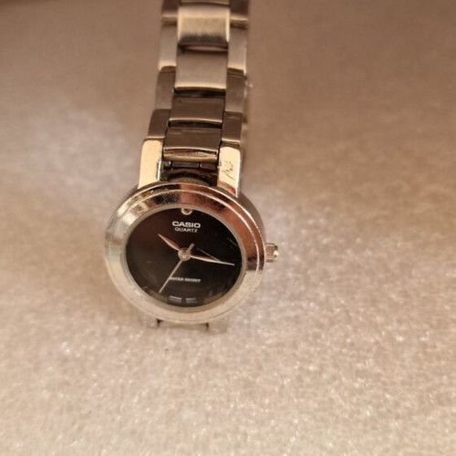 Casio women's watch used with black dial and metal bracelet