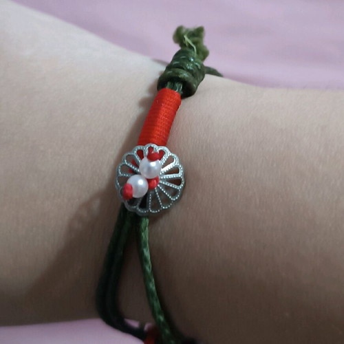 Bracelet new with various charms on green cord
