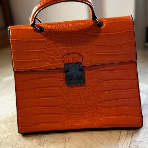 Orange shoulder bag like new made of sturdy material