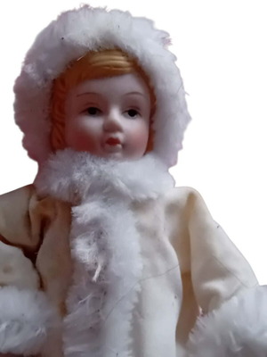 Porcelain doll with white velvet coat and faux fur used