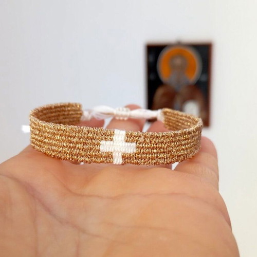 Woven bracelet with metallic gold cross new, white cotton thread