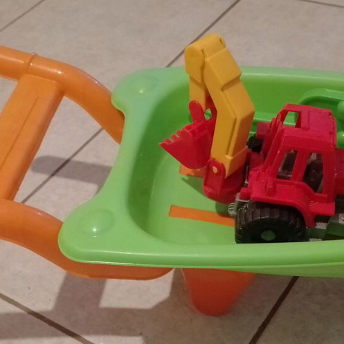 Beach toy set: plastic wheelbarrow, shovel, rake, small excavator