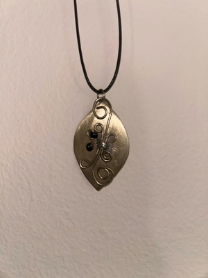 Necklace used with silver pendant and leather cord