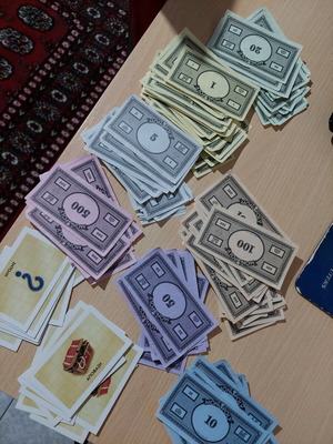 Monopoly money and decision cards in good condition