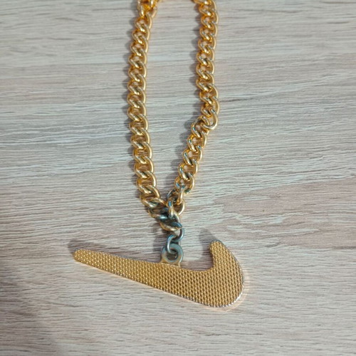 Nike decorative pendant with chain used, gold tone