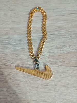Nike decorative pendant with chain used, gold tone