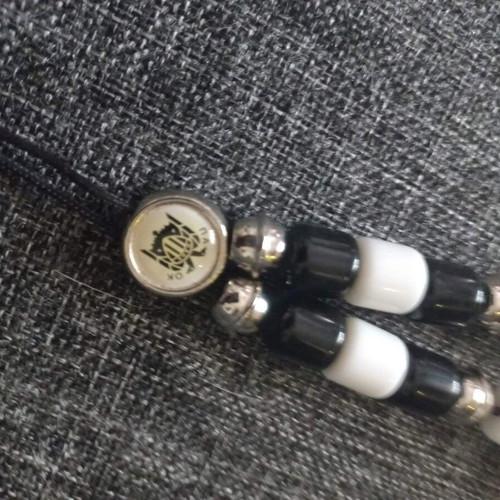 PAOK Komboloi like new, black and white with metal emblem