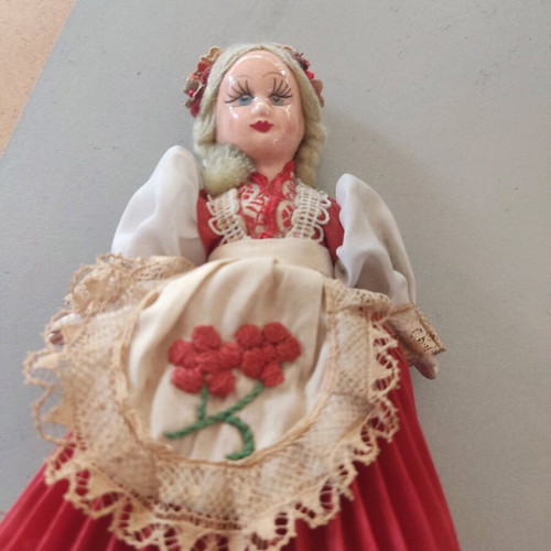 Vintage doll used with porcelain head and embroidered apron