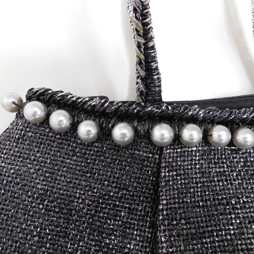 Handheld straw bag metallic like new with feather design and pearl accessory