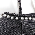 Handheld straw bag metallic like new with feather design and pearl accessory