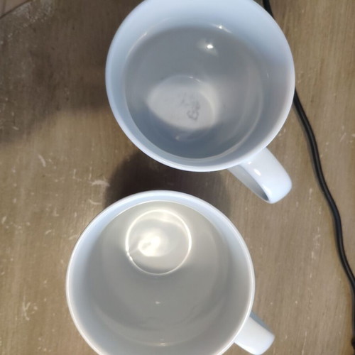 Two collectible mugs like new, featuring Moby and Charlize Theron design