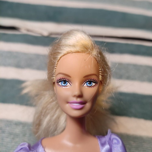 Barbie with lilac dress used, torn shoulders
