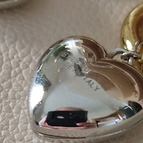Balenciaga earrings with two tone dangling hearts like new