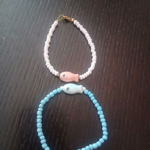 Two handmade island-style bracelets with beads and stone fish