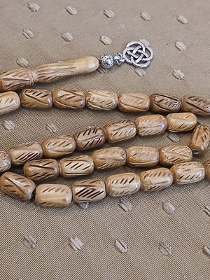 Camel bone worry beads used, 33 carved beads with metal elements