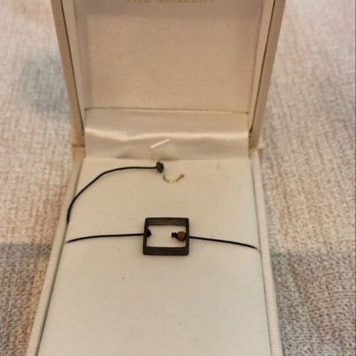 Minimalist bracelet like new with black cord and geometric square