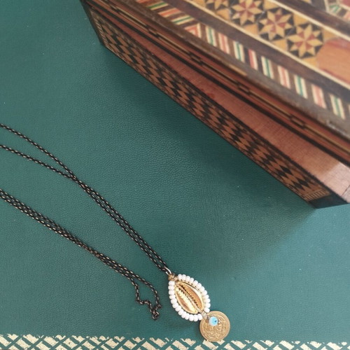 Long necklace with shell and evil eye pendant