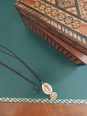 Long necklace with shell and evil eye pendant