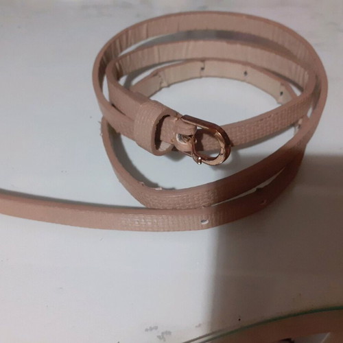Beige belt thin like new with embossed leatherette and gold buckle