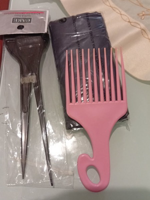 Hair care accessories set with pink afro pick comb and hair dye brushes