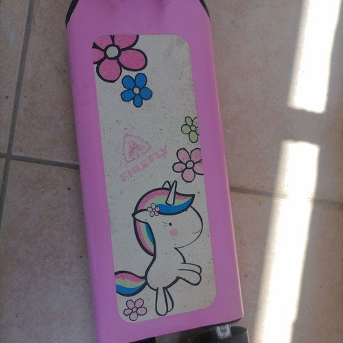 Pink children's scooter used with wear but fully functional