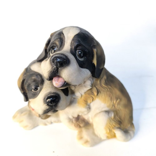 Decorative resin figurine of two puppies used