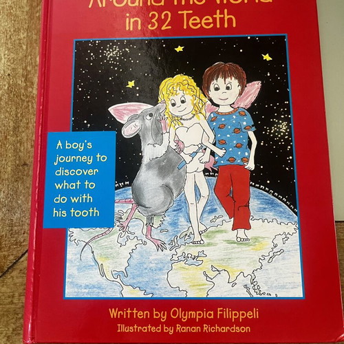 Around the World in 32 Teeth Hardcover book, signed by Olympia Filippeli